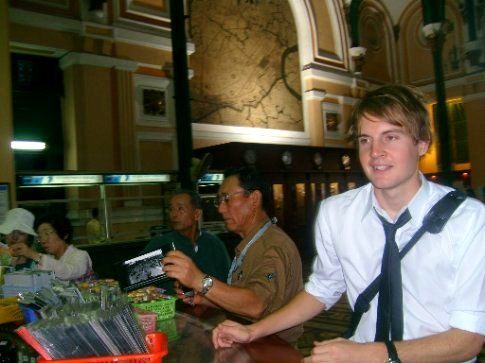 Sending a poscard in Ho Chi Minh City's famous post office.