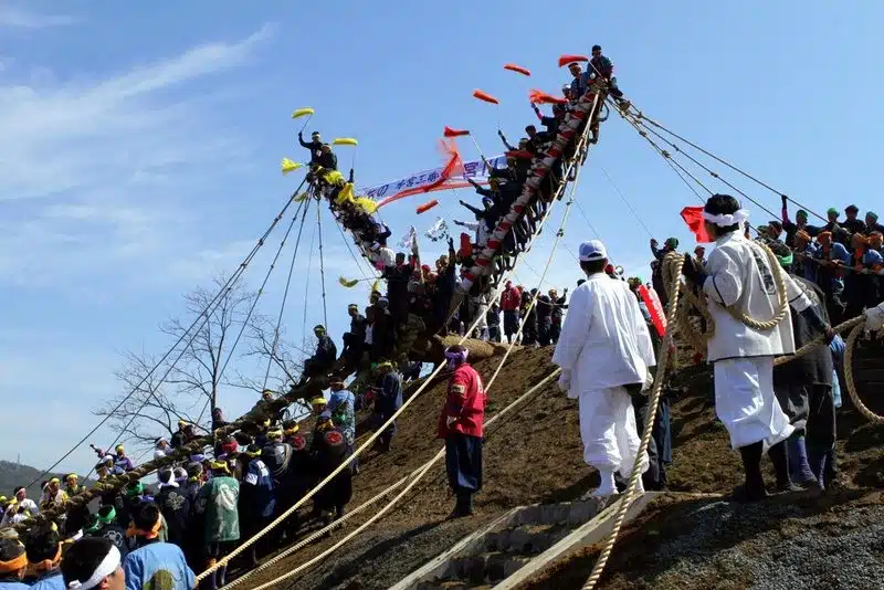 Dragging tree trunks through the streets in Ombashira Festival, Japan.