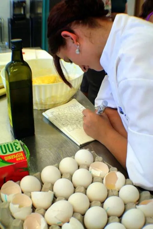 A student journaling between cooking lessons.