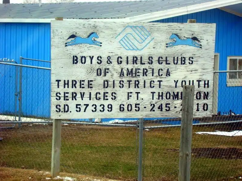 Boys and Girls club sign in Fort Thomspon, on the rez.