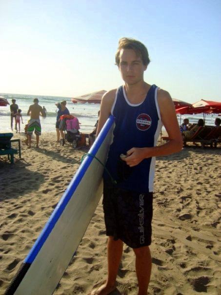 Squinting in the bright sun on Kuta Beach, with ruined ribs!