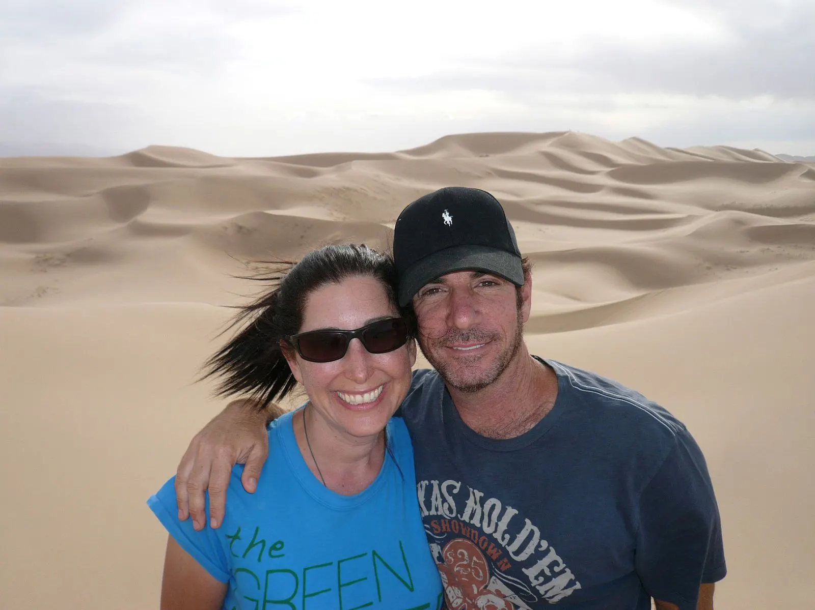 Lisa and George by exotic sand dunes during their travels.
