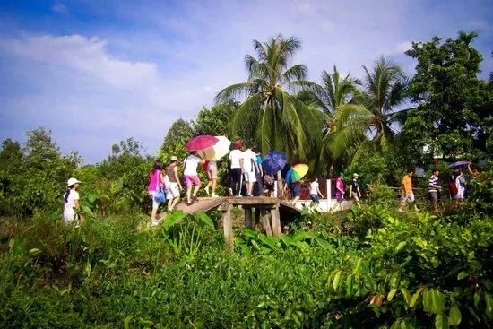 Elaine on a school trip in Vietnam, taking kids to the countryside.