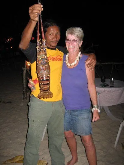 Triumphantly holding a lobster in Thailand.