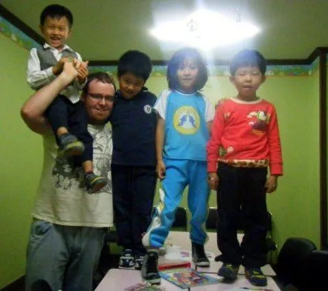 Chris getting climbed upon by students.