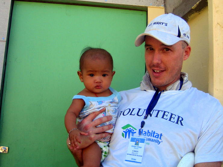 Chris and a new friend during Habitat for Humanity in the Philippines.