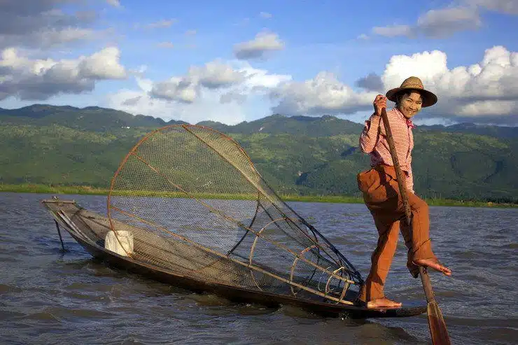 A great image as a leg rower showcases his talent on Inle Lake.