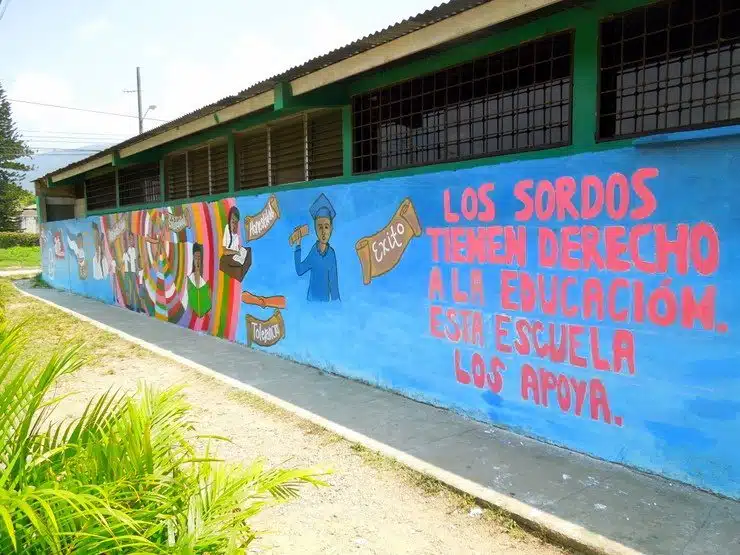 The completed mural confidently states, "The deaf have a right to education. Support this school."