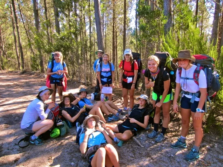 Resting with students during a long Odyssey hike through the bush.