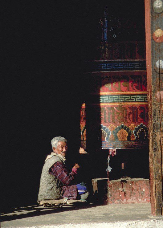 This Buddhist man spends his days spinning the colorful prayer wheel in Bhutan.