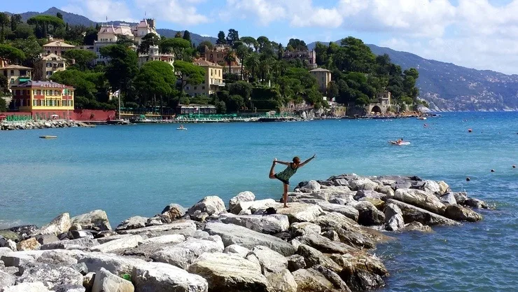 Fenesha in Santa Margherita, Italy, striking a yoga pose.