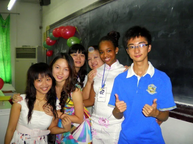This picture was taken in Beijing, China with a few of Jamilah's students. She had purchased a traditional Chinese dress, which her students loved! In the back are balloons students arranged alongside the note &ldquo;I love you!&rdquo;