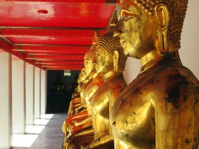 Rows of gold Buddhas at Wat Pho in Bangkok.