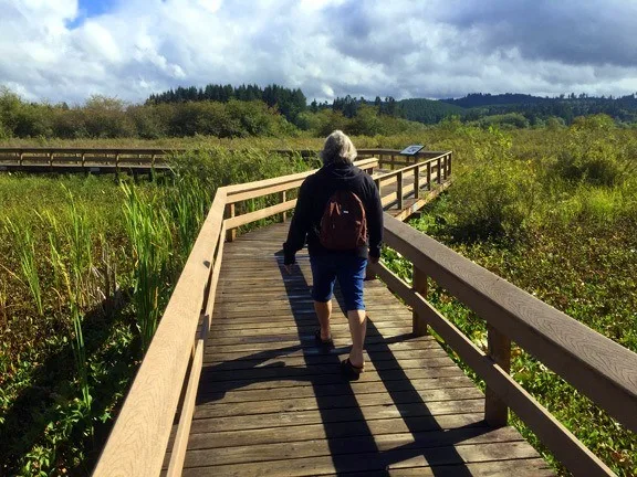 Louise walking on a board walk in Washington.