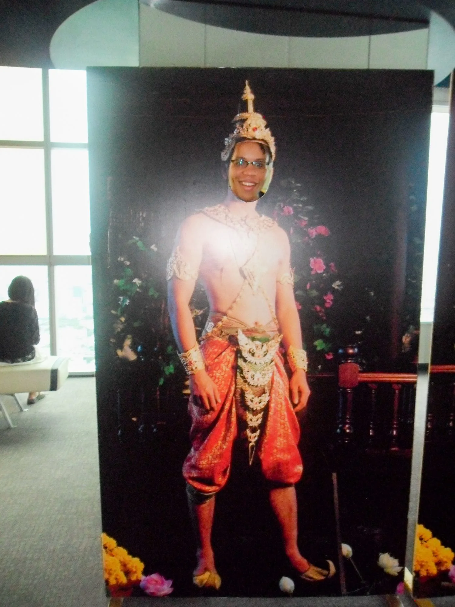 Visiting the tallest building in Thailand and posing behind this poster of traditional Thai dress.