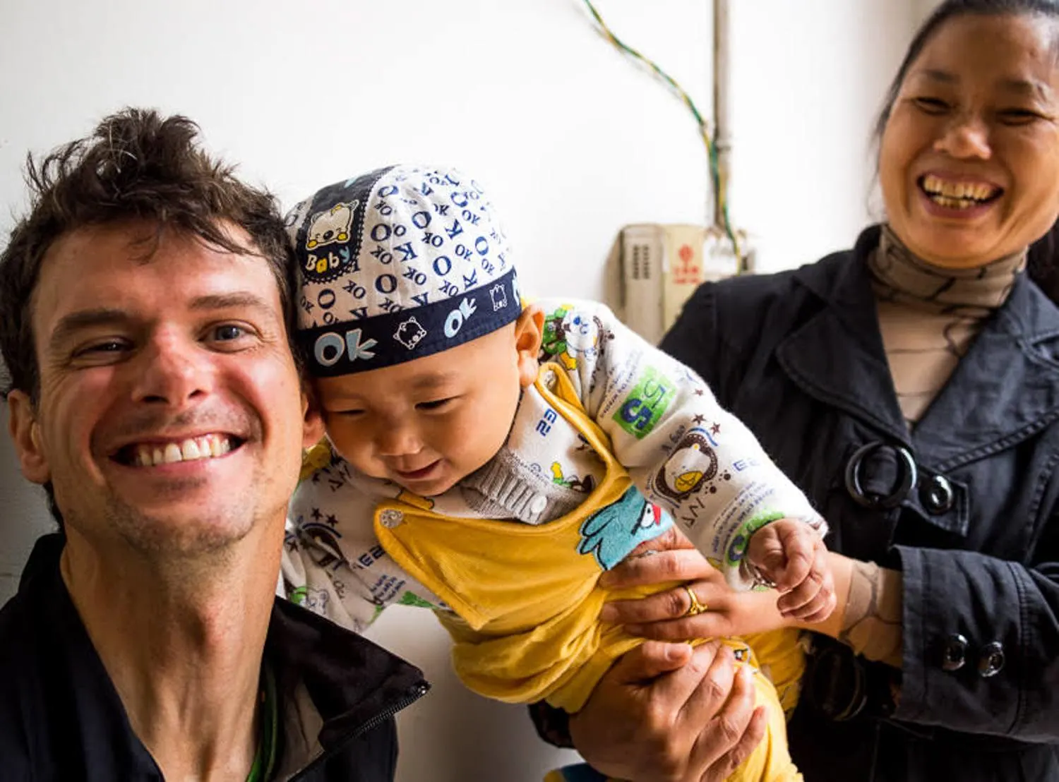 In small villages, people would often bring their babies to meet the strange foreigners.