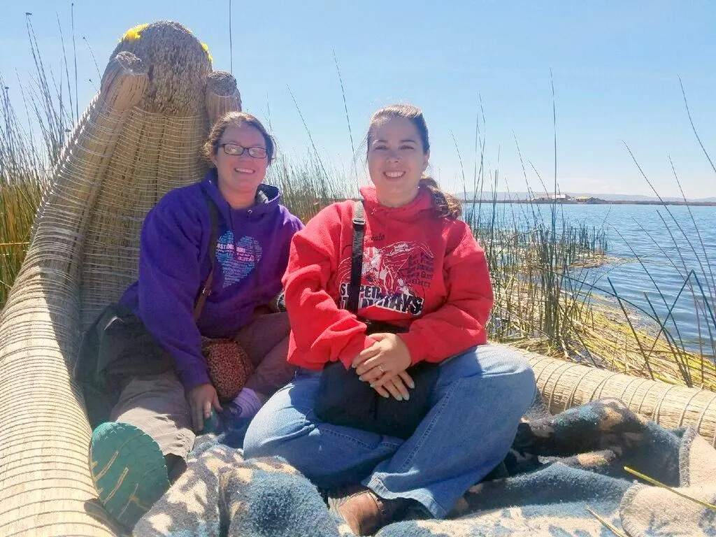 The traveling teachers on a reed boat, exploring the lake.