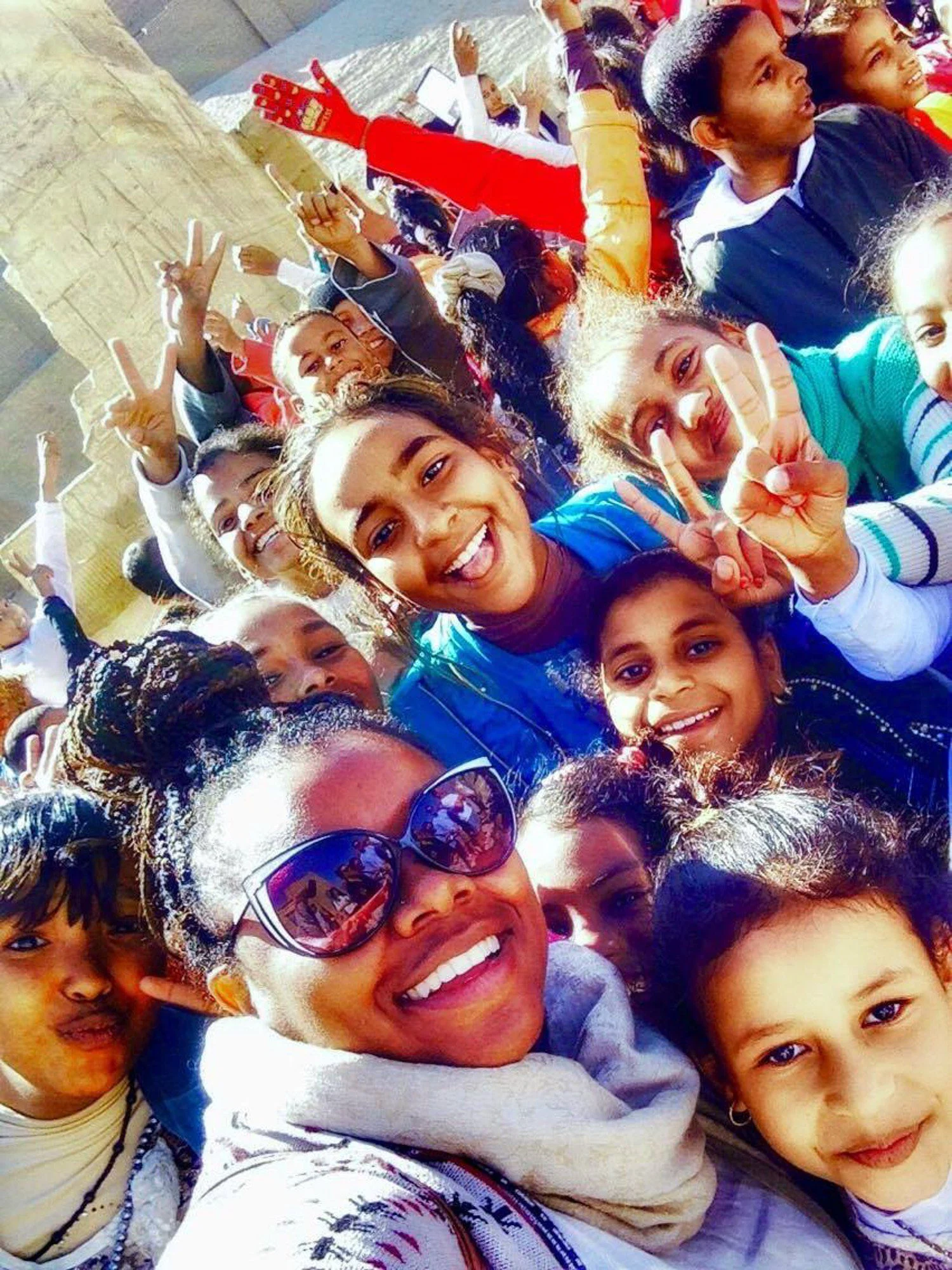 Surrounded by children on a field trip at the Temple of Hatshepsut in Egypt.