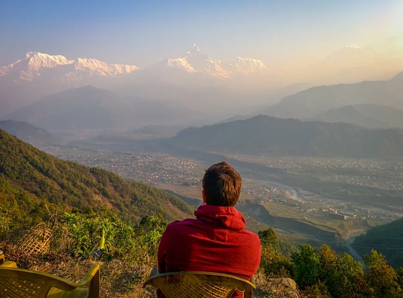 Tim in Nepal, gazing out at the mountains.