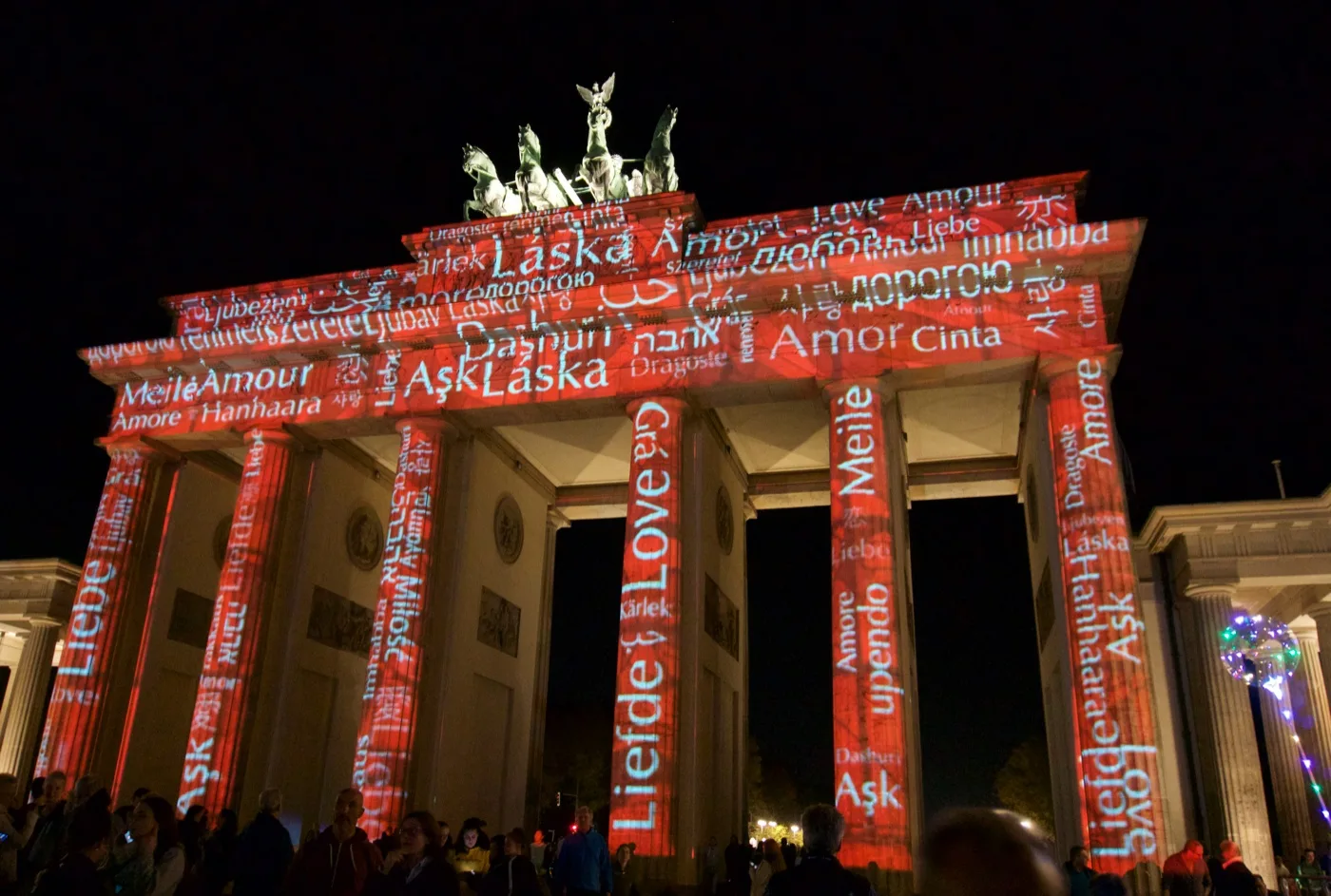 Brandenburg Gate lit up with words. Berlin, Germany: Teacher Fellowships for Social Studies Travel