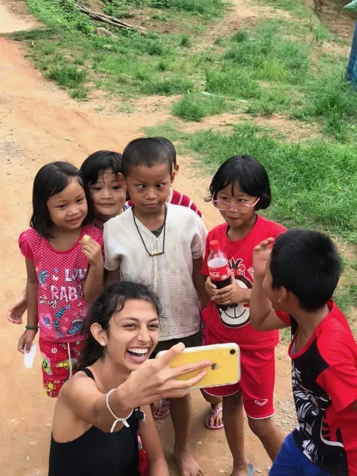 Taking photos with new friends abroad.