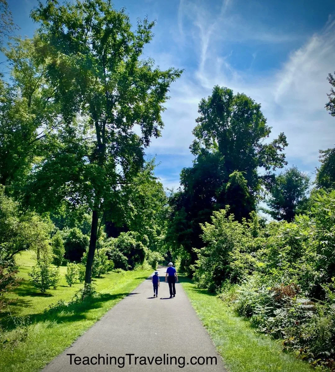 Walking on bike path with dark shadows and bright light.