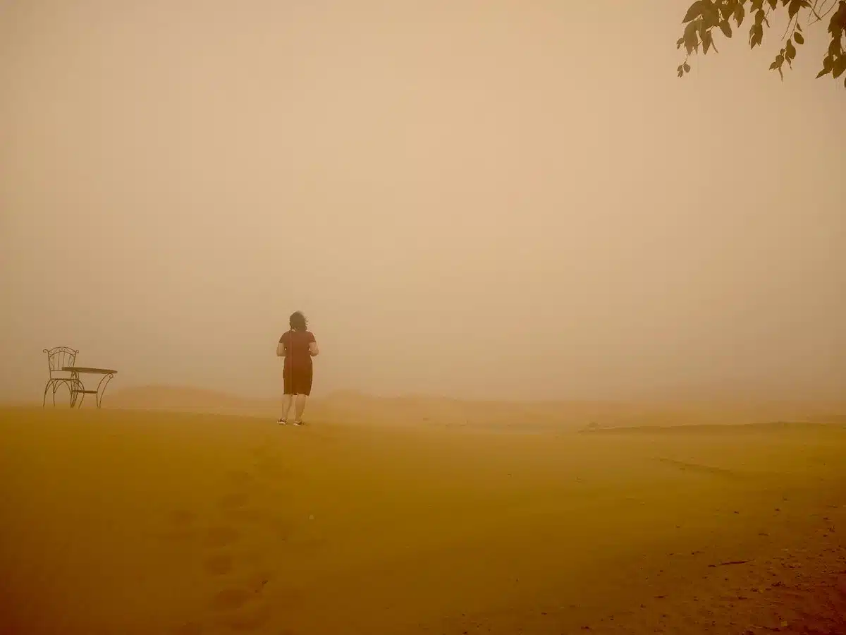 Gina standing outside of their hotel in the Sahara Desert.