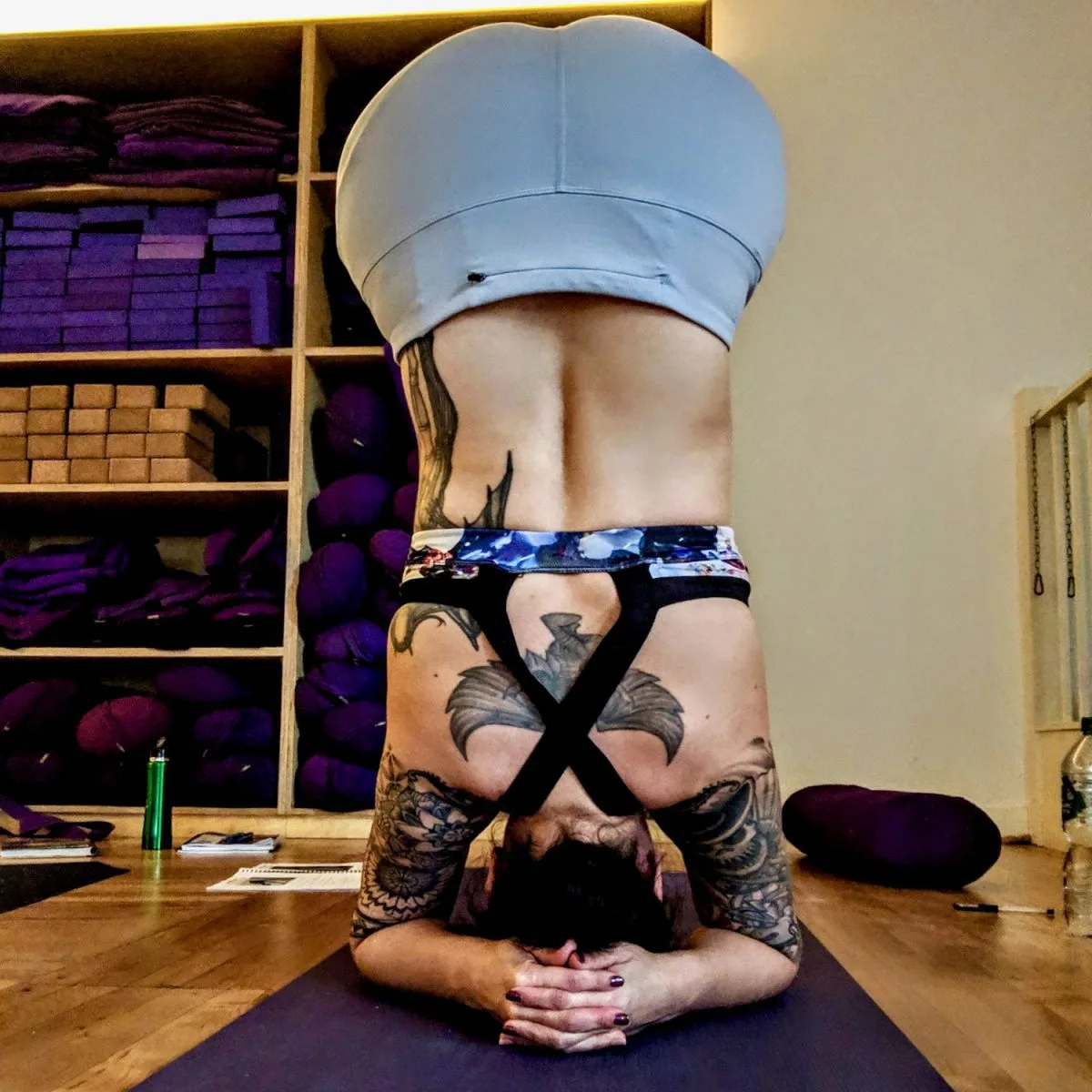 Practicing a yoga headstand.