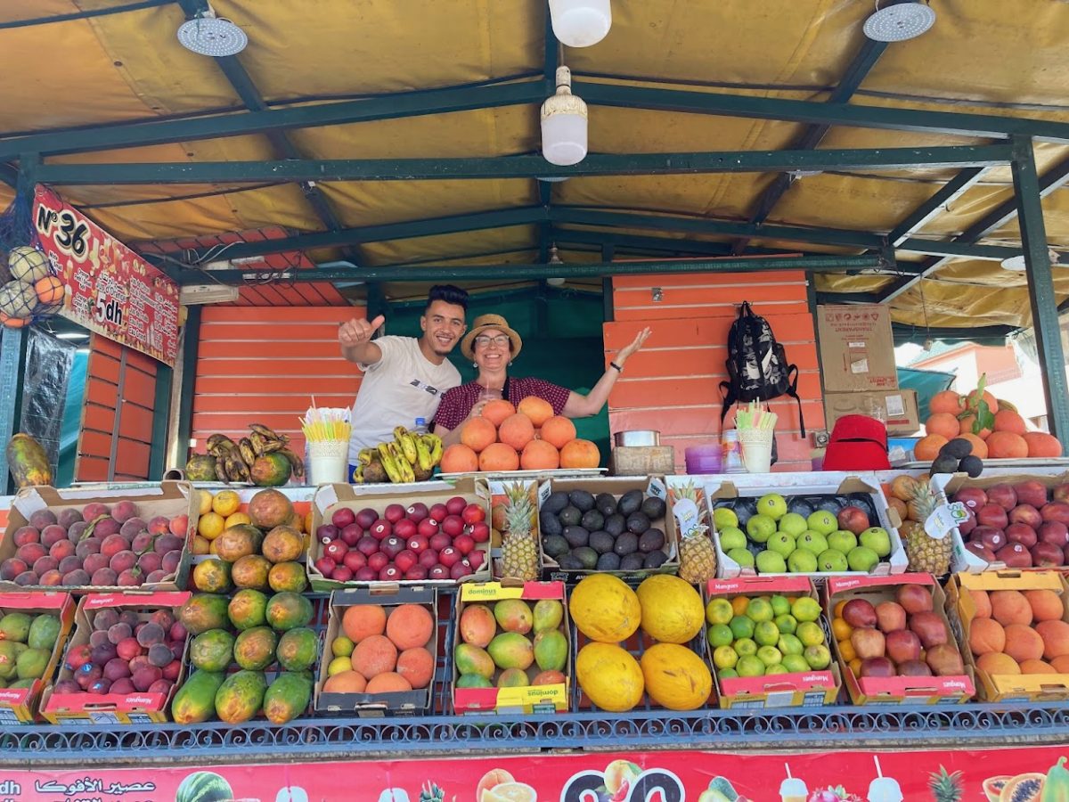Posing with fruit sellers in Morocco.