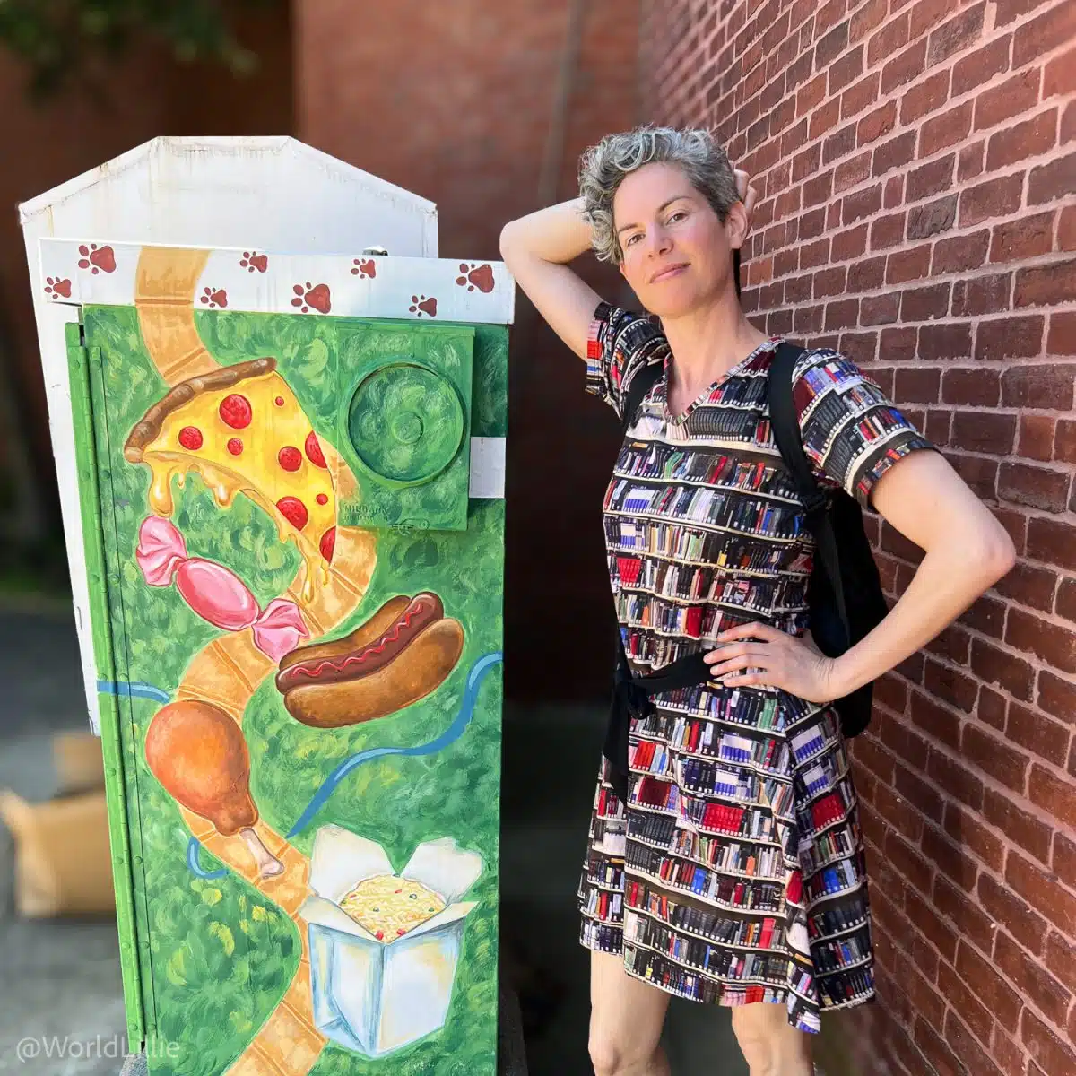 Posing with a funny mural with my book dress.